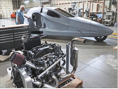 An image of a workshop with a flying car
