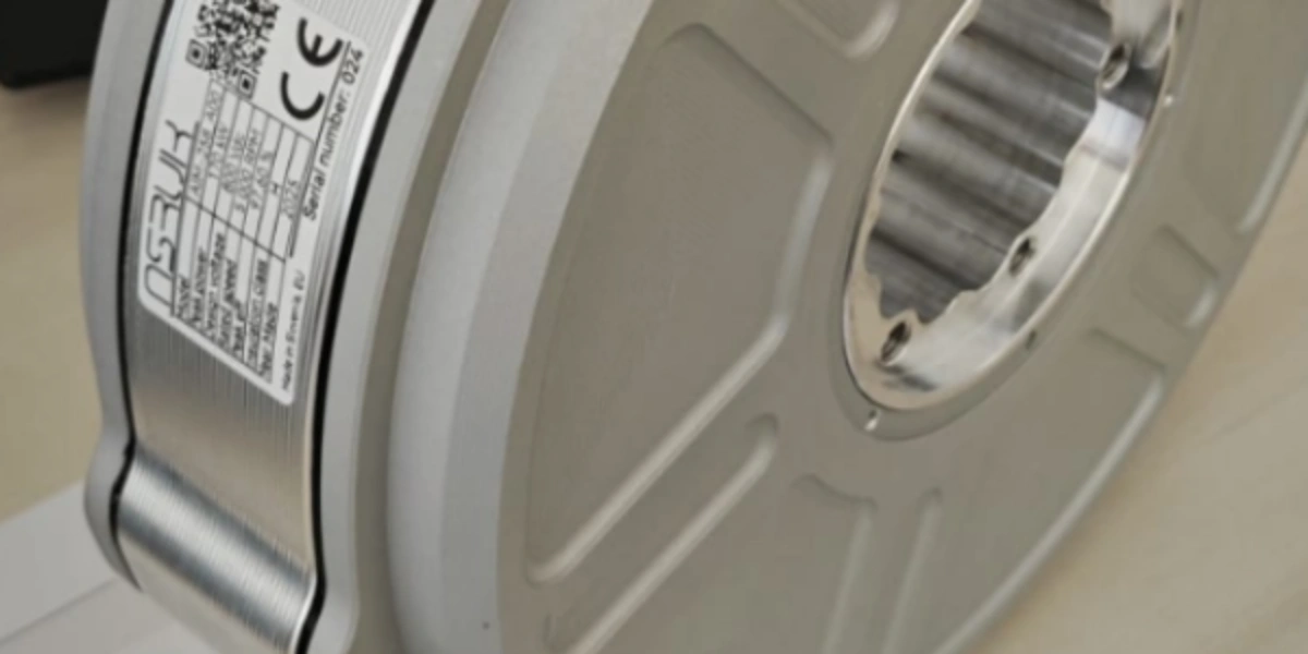 Silver industrial component with 'OSUK' product label, serial number 024, and ridged metallic interior.