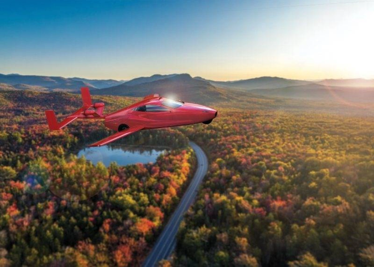 Red futuristic flying car flying over autumn forest landscape at sunset