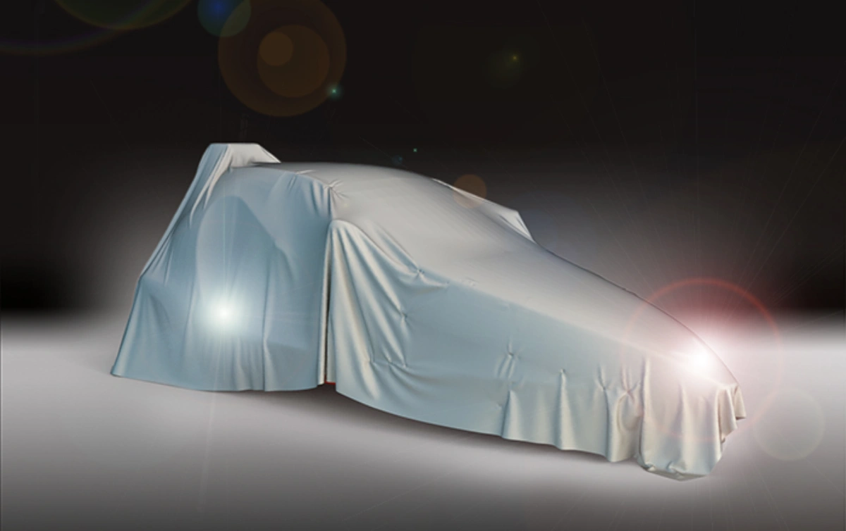 Covered car silhouette with spotlight on dark background