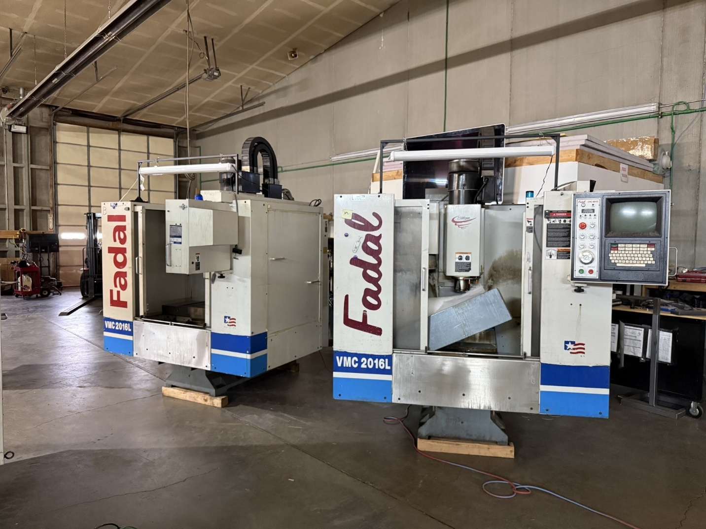 Two Fadal VMC 2016L vertical machining centers in a workshop.