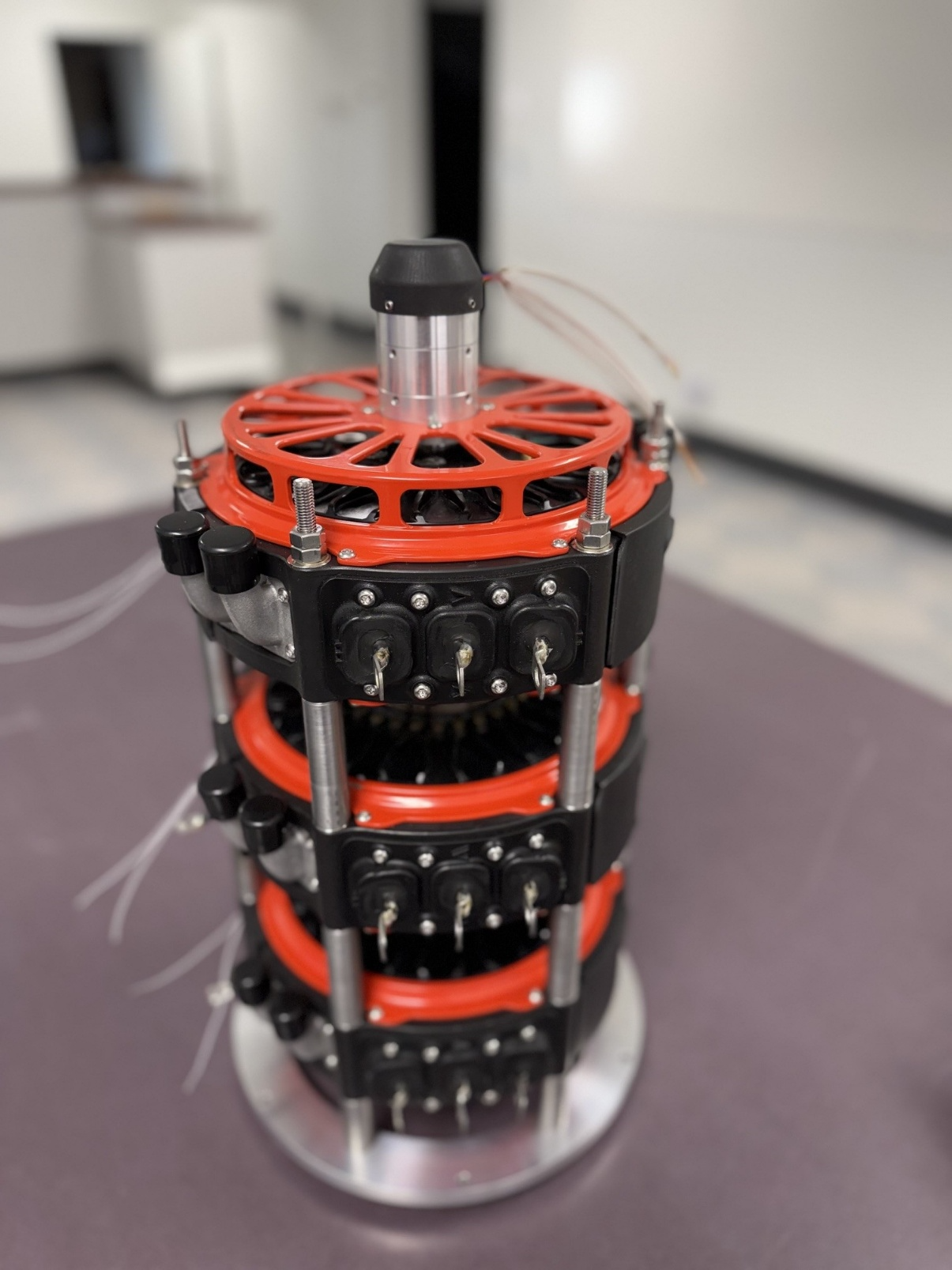 Prototype custom high-voltage motor with integrated capacitor bank and multiple safety interlocks.